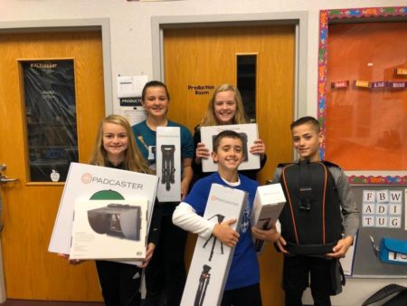 Students holding boxes of equipment